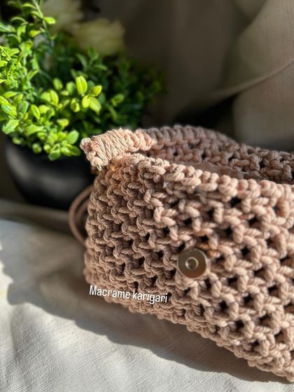 The back of our macramé sling bag, showing the secure magnetic button closure. We design our bags to be not only beautiful but also practical for everyday use.