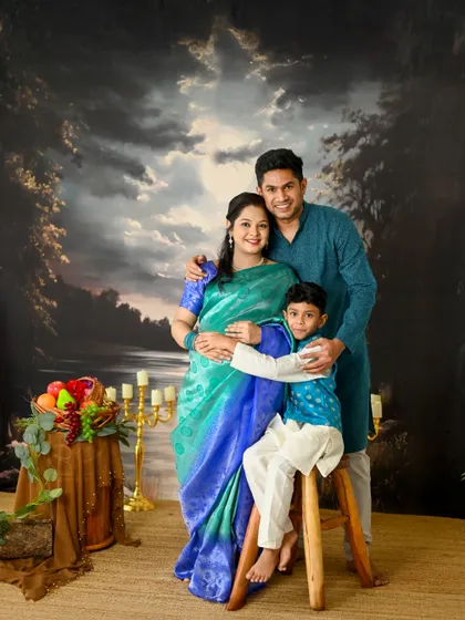 A classic family portrait is timeless. In my studio, I use professional lighting and beautiful backdrops to create elegant portraits like this one, where the family is coordinated in traditional wear. It's a perfect way to capture your family's bond.