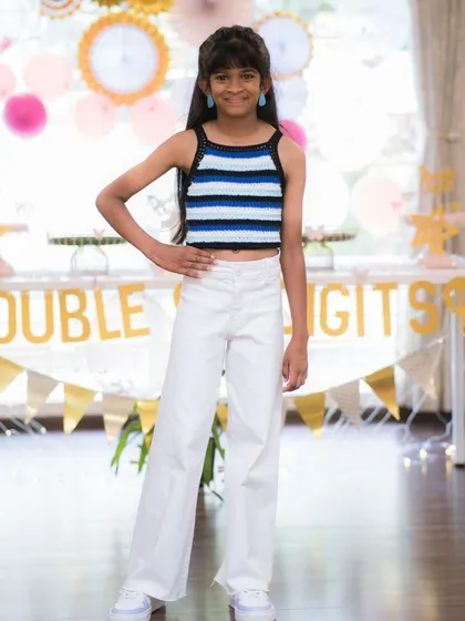 It makes my day to see happy clients like this. She’s celebrating her birthday in a custom-fit halter neck top I made for her. The striped pattern is crocheted with black, blue, and white yarn.