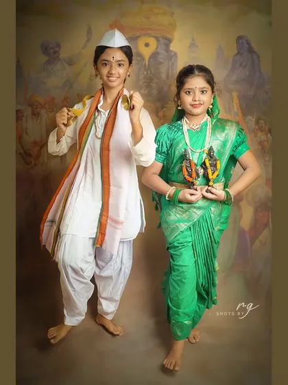 A full-length portrait of two friends dressed in traditional Varkari attire against a backdrop depicting the pilgrimage.