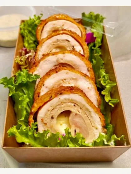 Our Chicken Cordon Bleu roulade, sliced and served on a bed of lettuce. A classic continental dish, elegantly presented for your event.
