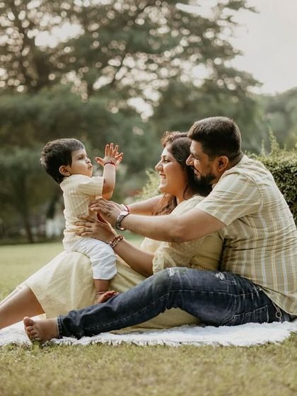 Playful interactions are the heart of my family sessions. Here, parents engage their little one with gentle touches and happy expressions, creating a candid portrait full of life and love.