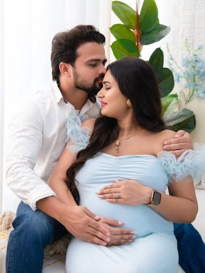 A tender forehead kiss is a simple yet powerful expression of love and support. This close-up shot captures the deep affection between the partners during their maternity session.