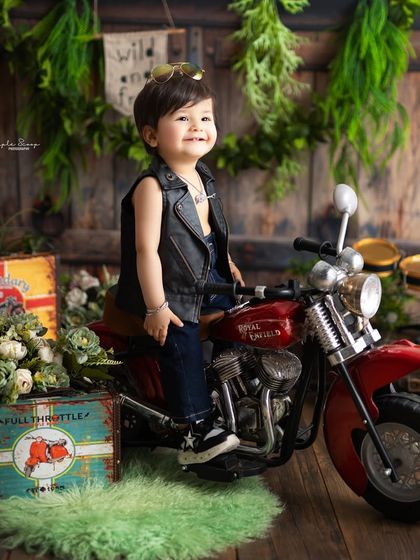 This handsome little guy is ready to hit the open road. The 'Wild and Free' biker theme is a fun and edgy choice for a first birthday shoot.
