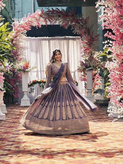 A video showing the client joyfully twirling in the mauve-purple lehenga.