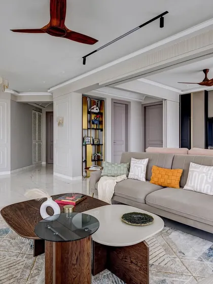 Another angle of the 'Urban Tranquility' living room, showing the flow into the entryway. The design uses consistent colors and materials to create a harmonious and expansive feel.