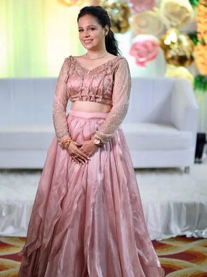 The full view of Komal's elegant engagement guest look. The makeup is soft and pretty, letting the outfit shine.