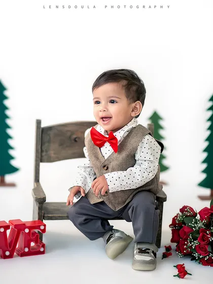 A dapper little gentleman sitting on a bench, surrounded by roses. This setup was perfect for a Valentine's or special occasion photoshoot.