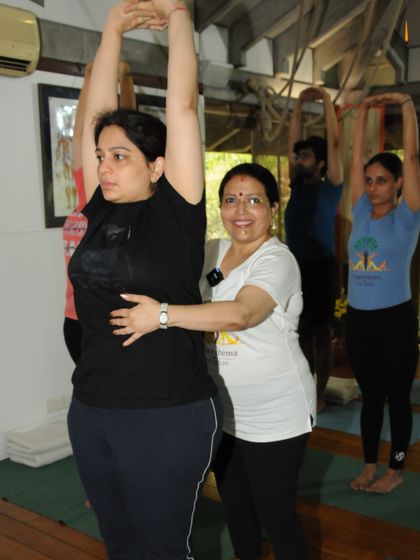 To care for others, you must first care for yourself. Here, I am helping a student find length and space in her torso, a key step in reconnecting with her inner strength.