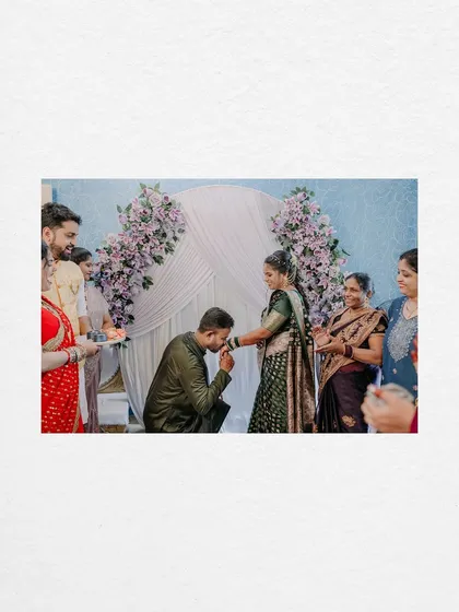 A traditional and chivalrous moment as the groom kisses the bride's hand after placing the ring on her finger.