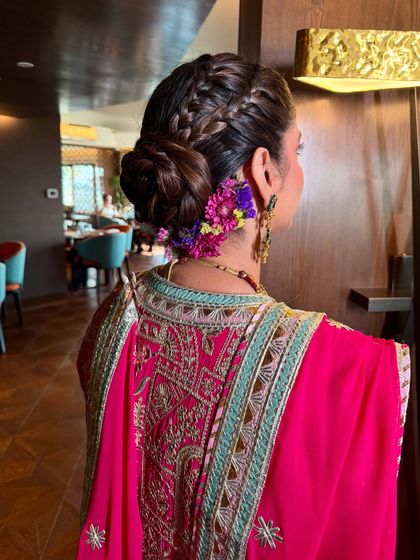 Another view of this stunning floral braided bun. The combination of the intricate braid and the fresh flowers creates a look that is both romantic and elegant.