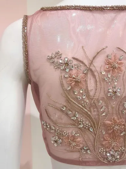 A crystal and organza flower embellished blouse designed for a beautiful pastel Benarasi saree, featuring a sheer back.