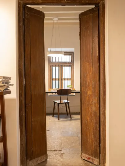 A simple doorway can frame a beautiful story. Looking through these old wooden doors, you see a quiet corner with a single chair by the window. It’s a reminder that beauty often lies in the simplest, most unassuming moments.