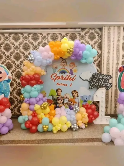 A vibrant Cocomelon first birthday setup for Sprihi. We used a custom backdrop featuring all the main characters and a colorful arrangement of balloons to create a fun and cheerful party atmosphere.