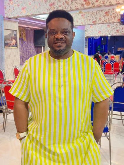 A happy client from abroad in a bright yellow and white striped kurta. My tailoring brings joy to clients across the globe.