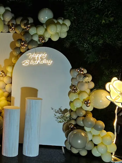 This view shows the full scope of the balloon decoration, elegantly framing the central backdrop for the 50th birthday celebration.