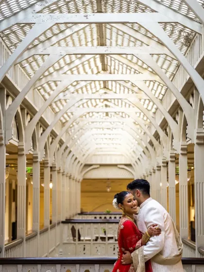 Using the stunning architecture of the venue to create a grand, editorial-style portrait. The leading lines of the corridor draw all the attention to the couple's embrace.