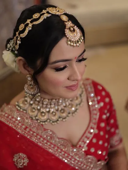 A close-up on Krusha's stunning eye makeup and jewelry. The look is regal, elegant, and perfect for a traditional bride.
