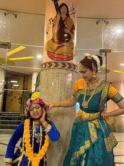 A classic pose of Yashoda scolding the naughty Krishna by pulling his ear. These playful interactions are a joy to enact on stage.