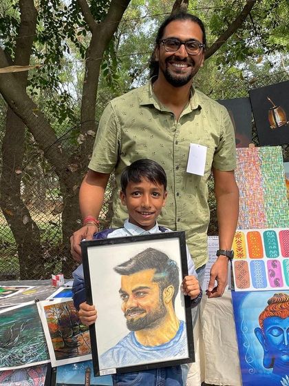 One of the best moments from the Chitra Santhe art festival. This young art lover picked up a portrait of his favorite cricketer. Seeing the joy on a client's face, no matter their age, is the greatest reward.