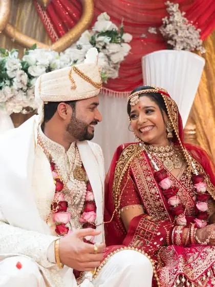 A candid shot of the couple sharing a look of love on their wedding stage.
