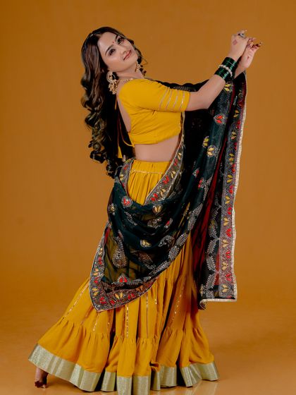 A dynamic shot capturing movement and the beautiful flow of the traditional skirt and dupatta. This is perfect for fashion campaigns that want to convey a sense of joy and celebration.