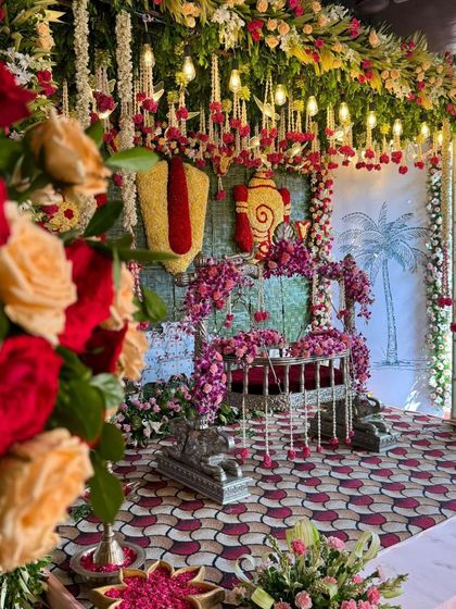 A beautiful shot of the naming ceremony cradle, framed by fresh roses in the foreground.