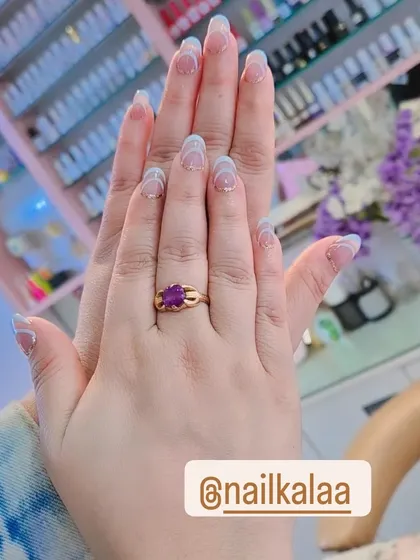 A subtle and chic design featuring a natural base with delicate, wavy white lines. This minimalist approach is perfect for an understated yet stylish manicure.