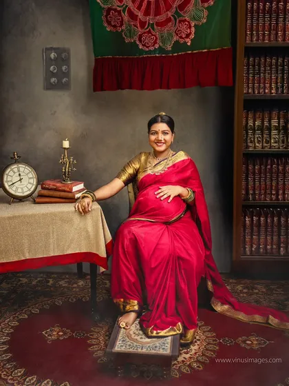 Seated with poise in a classic library, this portrait has a regal quality. The composition and her confident smile create an image of a knowledgeable and powerful mother.