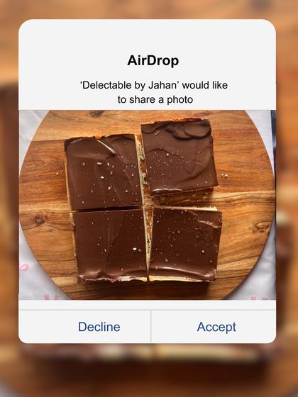 A top-down view of my Millionaire Shortbread, cut into four generous squares. This decadent treat features three distinct layers: a crumbly shortbread crust, a chewy caramel center, and a crisp dark chocolate top.