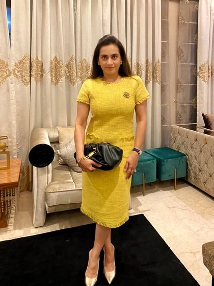 Another look at this beautiful yellow tweed dress. The classic cut and vibrant color make it a standout piece that feels both modern and timeless.