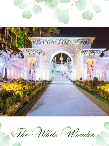 The "White Wonder" entrance in all its glory. This grand, carved facade, adorned with white flowers and illuminated by soft light, creates an unforgettable first impression of pure elegance.