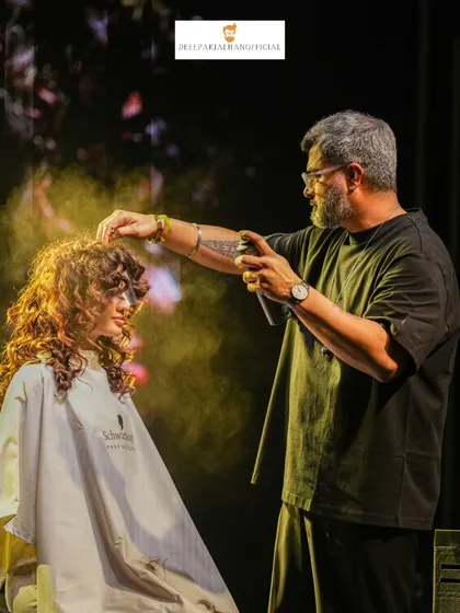 In the zone, adding the final touches on stage. This shot captures the energy of a live demonstration, where I use products like hairspray to lock in the texture and volume of these defined curls for the Schwarzkopf Lived-In Show.