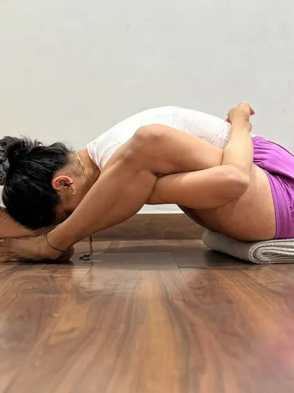 This complex seated forward bend, a variation of Kurmasana (Tortoise Pose), involves deep hip opening and spinal flexion. The pose is introspective, drawing the senses inward and calming the mind.