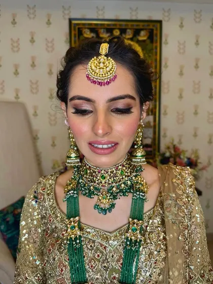 This shot focuses on the beautiful makeup and how the updo keeps the hair neatly away from the face, allowing the jewelry to shine.