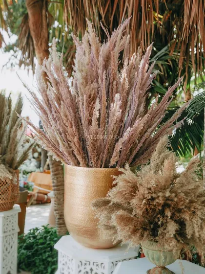 A close-up of the pampas grass decor. We used different varieties of dried grasses in textured pots to create stunning, voluminous arrangements that are both sustainable and beautiful.