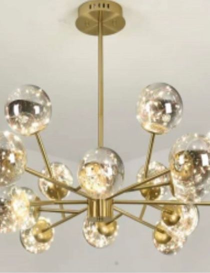 This new arrival is a sputnik-style chandelier featuring multiple smoked glass globes with internal fairy lights. It's a large, expansive fixture ideal for making a grand statement in a living room or double-height entryway.