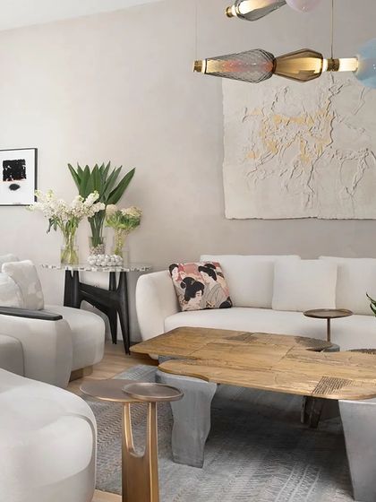 A vignette of our Koko furniture, highlighting our focus on craftsmanship and contemporary elegance. The 'Curved Couch', 'Twin Table', and 'Plateau Coffee Table' showcase our use of cast brass, recycled materials, and luxurious velvets to create unique, artistic pieces.