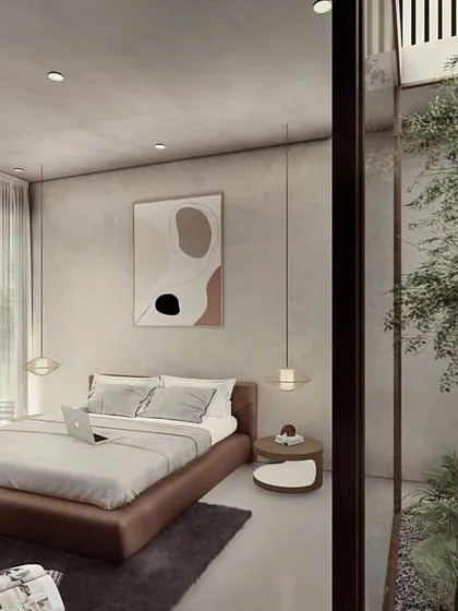 A bedroom in the Pavilions in the Fields project, with an internal courtyard garden. The space is designed to be a minimal, peaceful retreat, with large windows that open directly to the landscape.