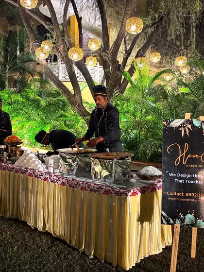 A live chaat counter set up under beautiful evening lights at a wedding, providing guests with delicious and interactive food options.