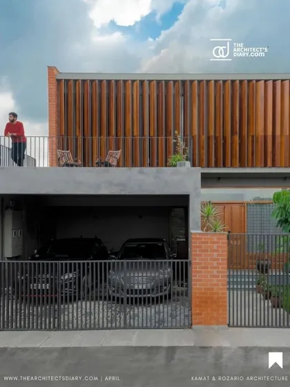 The 'Screen House' facade features giant operable wood louvers that act as a dynamic curtain. This allows the homeowners to control the amount of sunlight and privacy, connecting the home to the outdoors on their own terms and creating an ever-changing exterior.