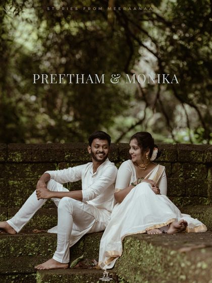 A beautiful pre-wedding portrait of a couple in traditional white attire, sitting together on ancient stone steps.