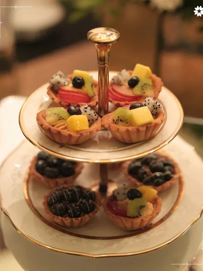 A classic two-tiered stand with fresh fruit tarts, perfect for a high tea or dessert spread at a home party. Our patisserie team creates beautiful and delicious treats for any occasion.