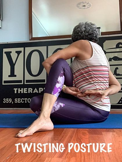 A seated twisting posture, which I teach with a focus on lengthening the spine before rotating.