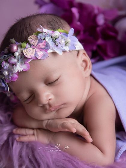 A close-up of this sleeping beauty, adorned with a butterfly and flower crown. The purple tones are calming and give the portrait a regal feel.