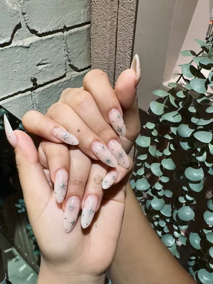A delicate and dreamy set featuring a sheer nude base with tiny, sparkling star details. It's minimalist with a touch of magic.