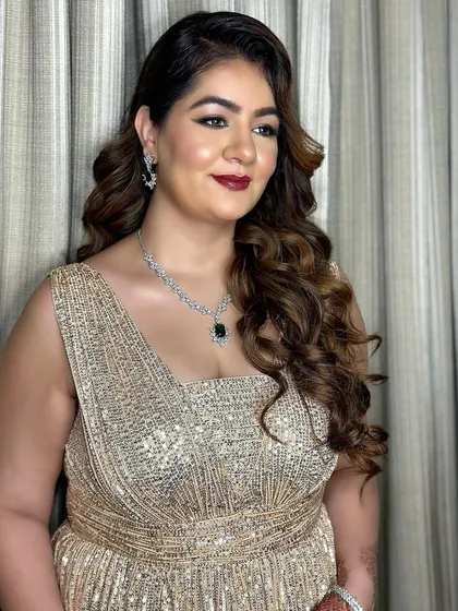 A final portrait of this stunning reception look. The glam makeup perfectly complements her sparkling gold gown.