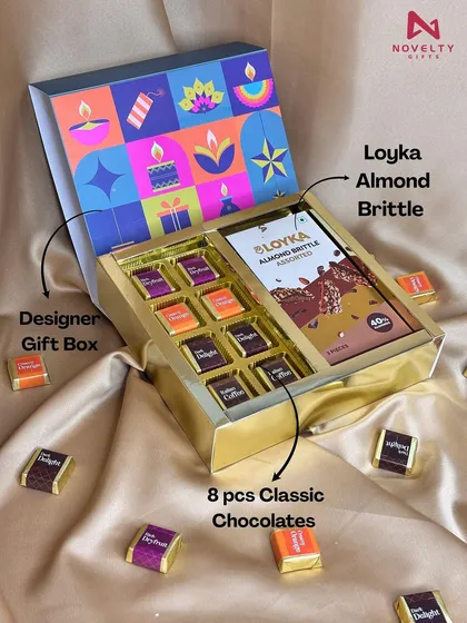 A modern take on festive gifting, this hamper features a designer box with contemporary Diwali graphics. Inside, a golden tray holds eight pieces of classic chocolates and a bar of Loyka Almond Brittle.