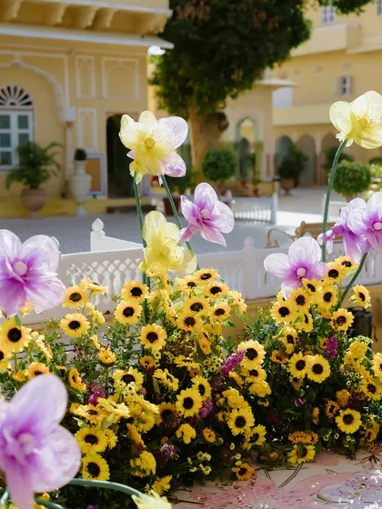 A close-up of the sunflower and oversized purple flower decorations, set against the beautiful architecture of Chomu Palace. This highlights our creative use of florals.