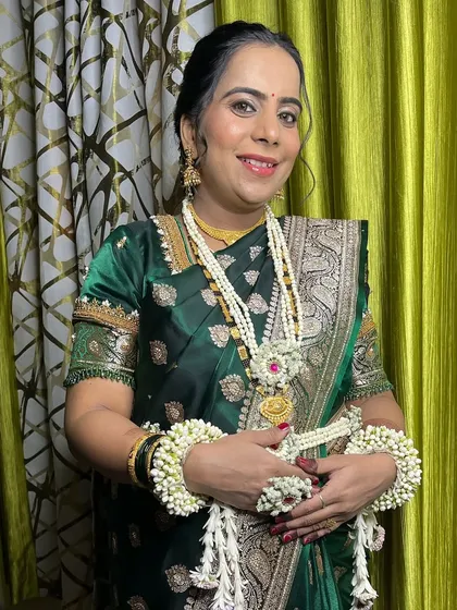 The client is adorned with traditional floral jewellery, which I complement with soft, natural makeup.